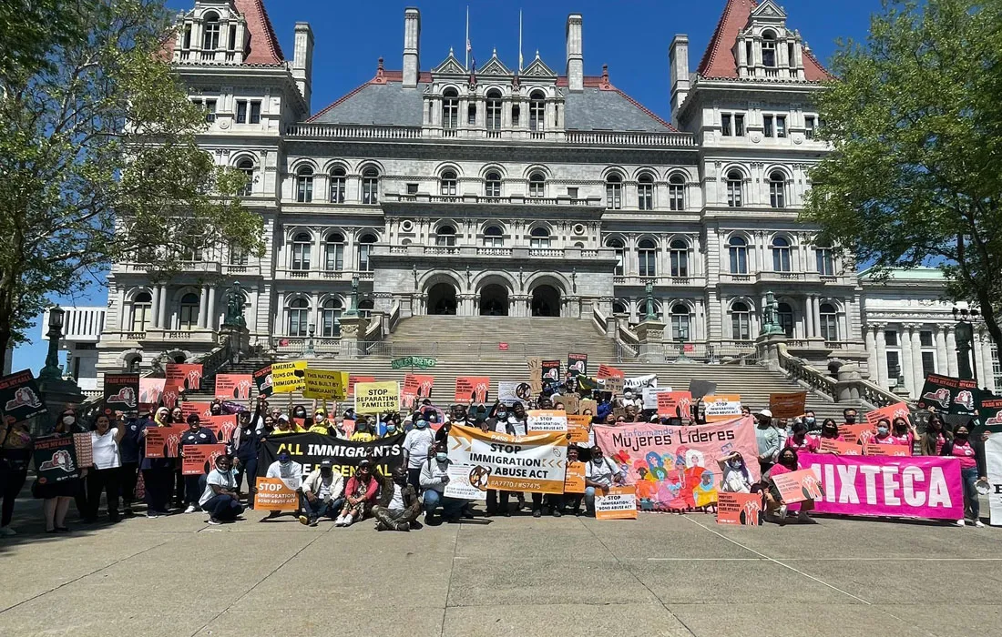 people gathering in front of building to protest