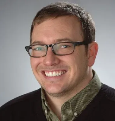 portrait of man wearing glasses smiling