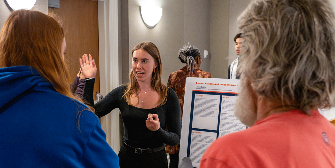 student presenting her poster