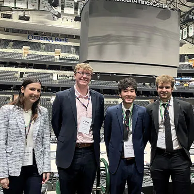 four people standing together