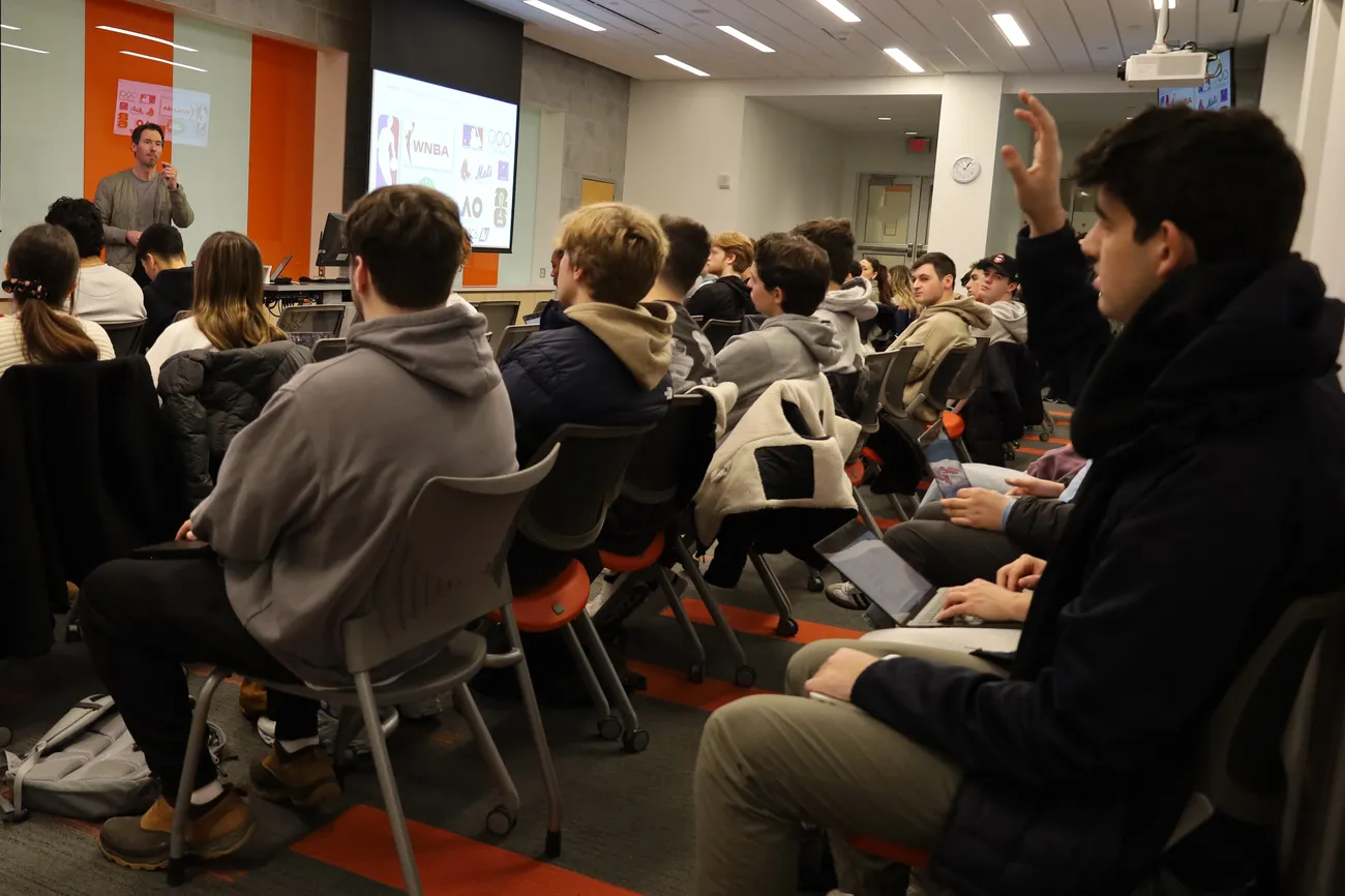 A student raises his hand in class.