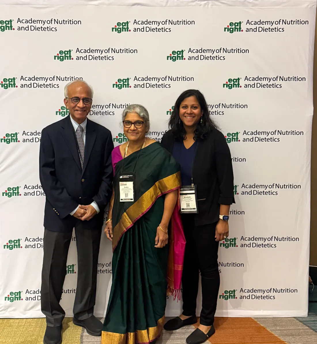 Sudha Raj stands with husband and daughter at medallion award