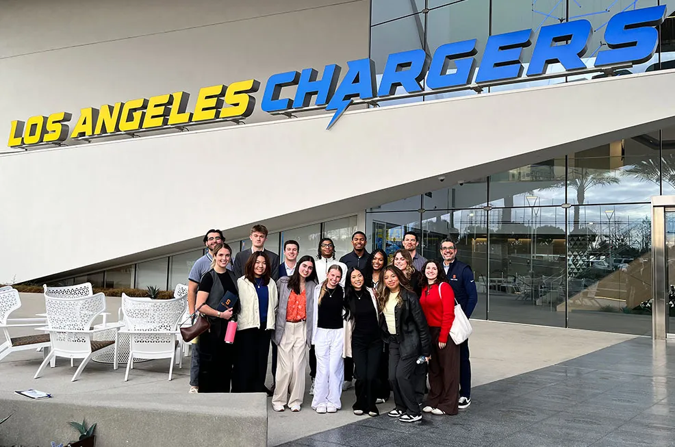 A group of students and staff with Dean Jeremy Jordan at the LA Chargers.