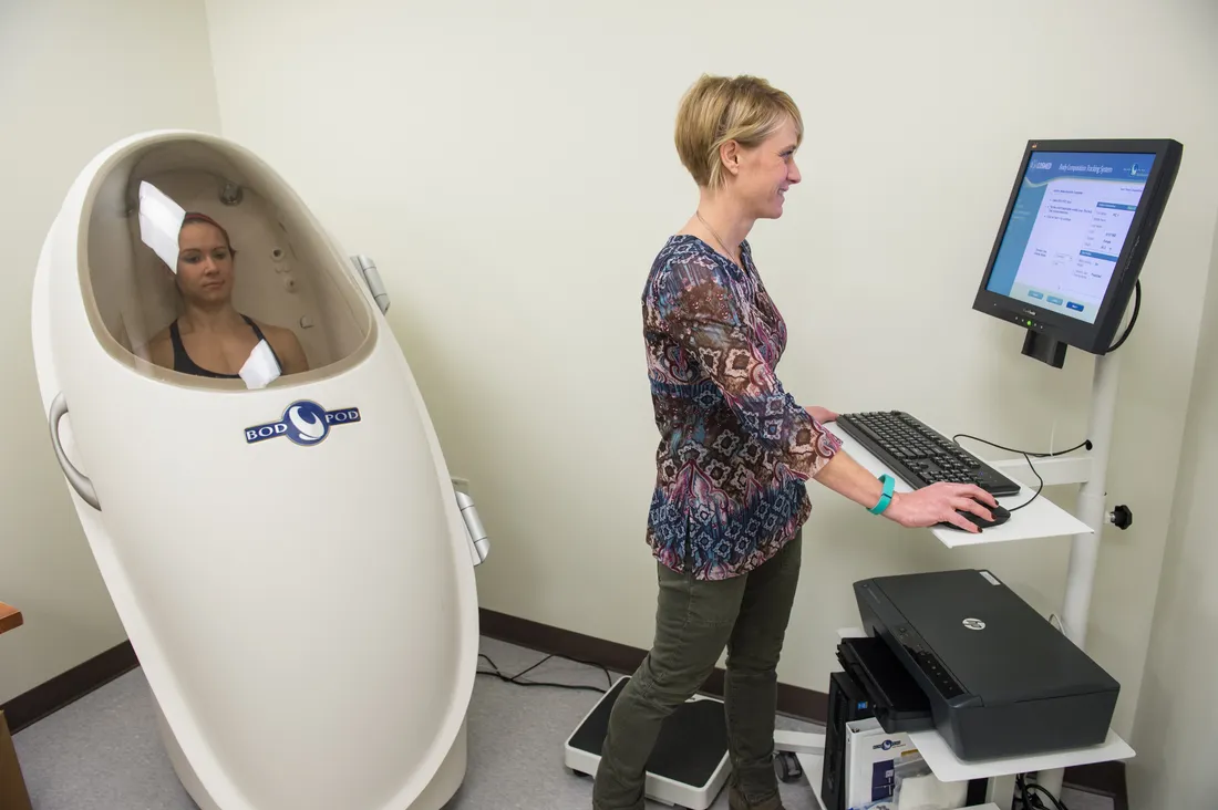 Professor operates a bod pod with a student inside