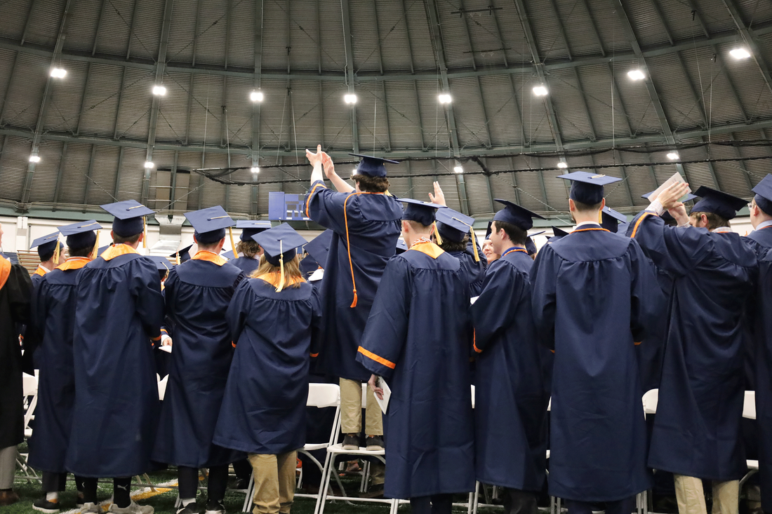 students applaud audience at convocation