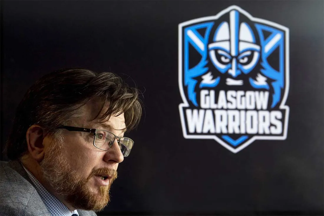 side view of bearded mans face with Glasgow Warriors logo to the right