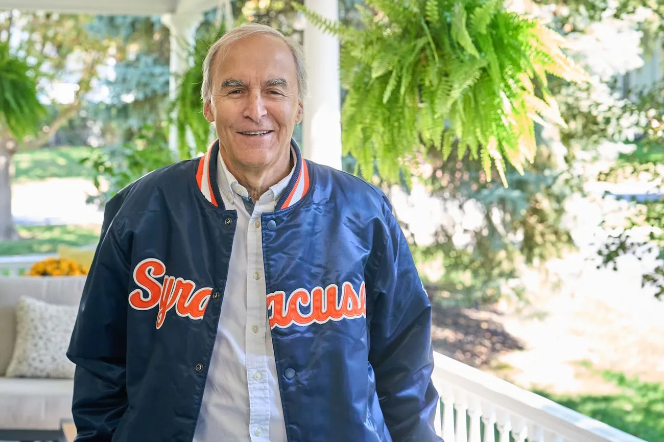 Rick Burton standing outside on a porch with plants behind him