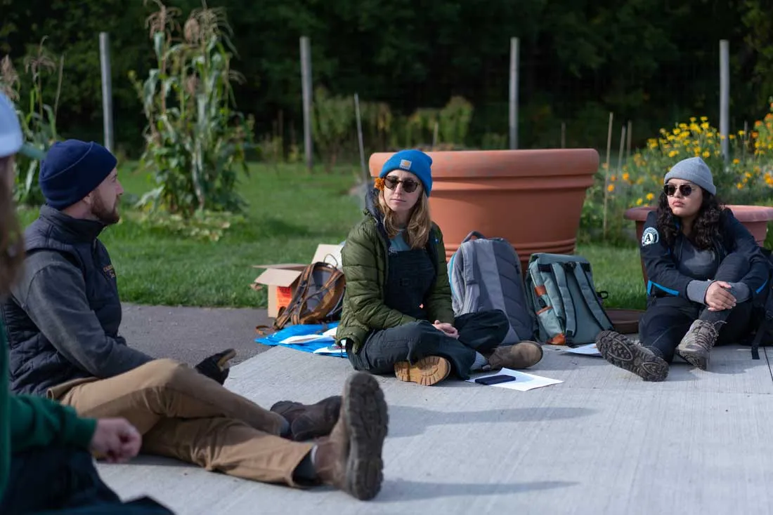 professor and students sitting outside