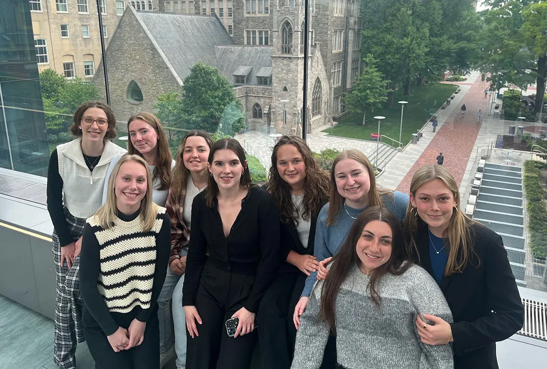 Nine young women standing together outside while on trip to Philadelphia