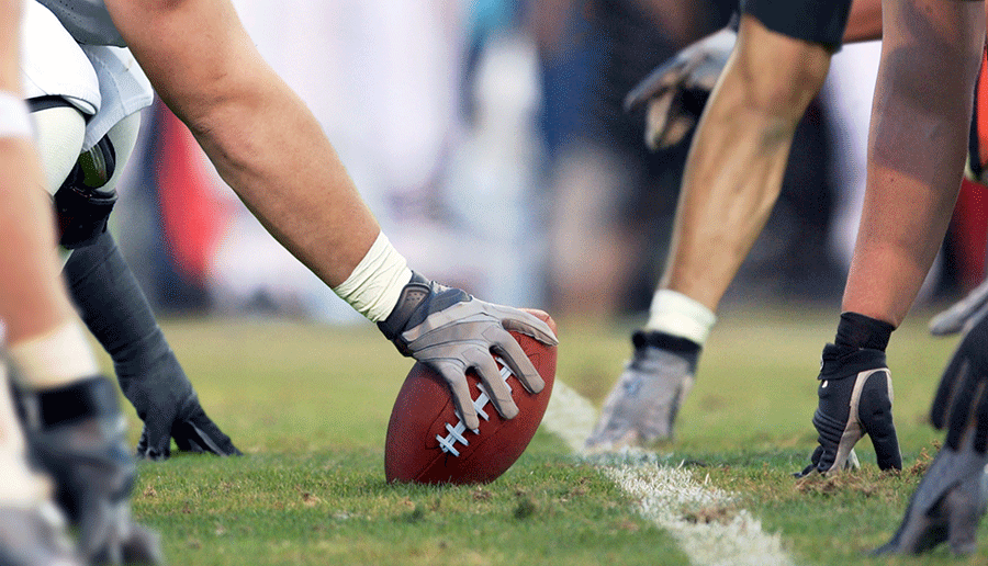 football and players on athletic field