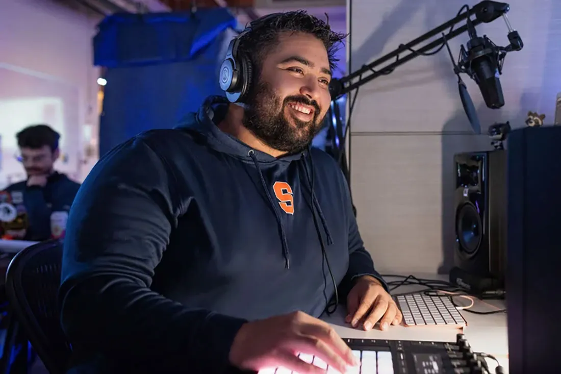 bearded man sitting at overhead microphone