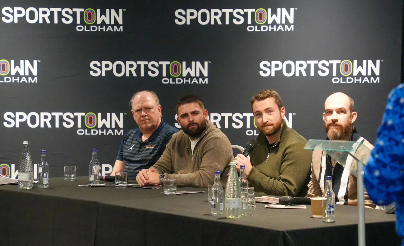 Panelists, including Falk College Chair of the Department of Sport Analytics Rodney Paul, Ph.D., seated at a table during the Oldham Athletic Football Analytics Conference