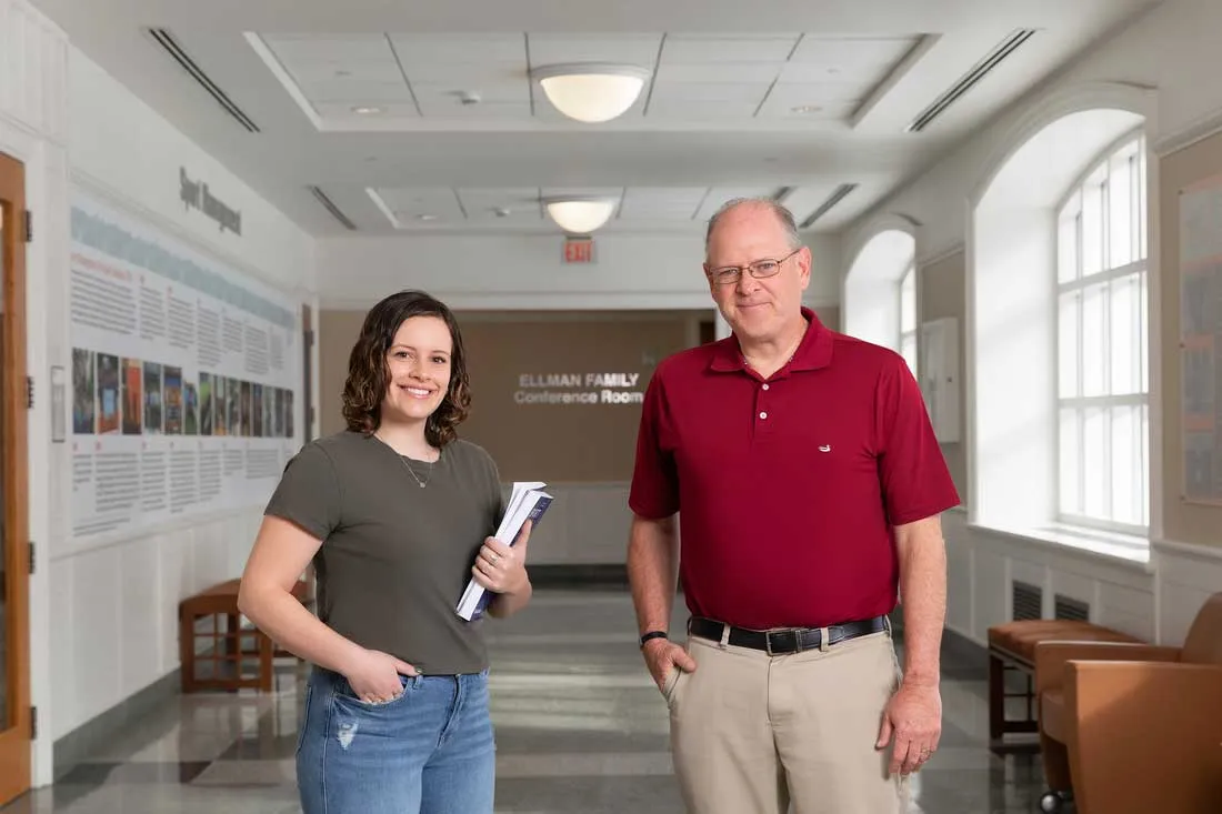 young women standing with her male professor