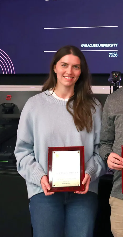 2026 Faculty of the Year award winner Kylie Harmon holds her award.