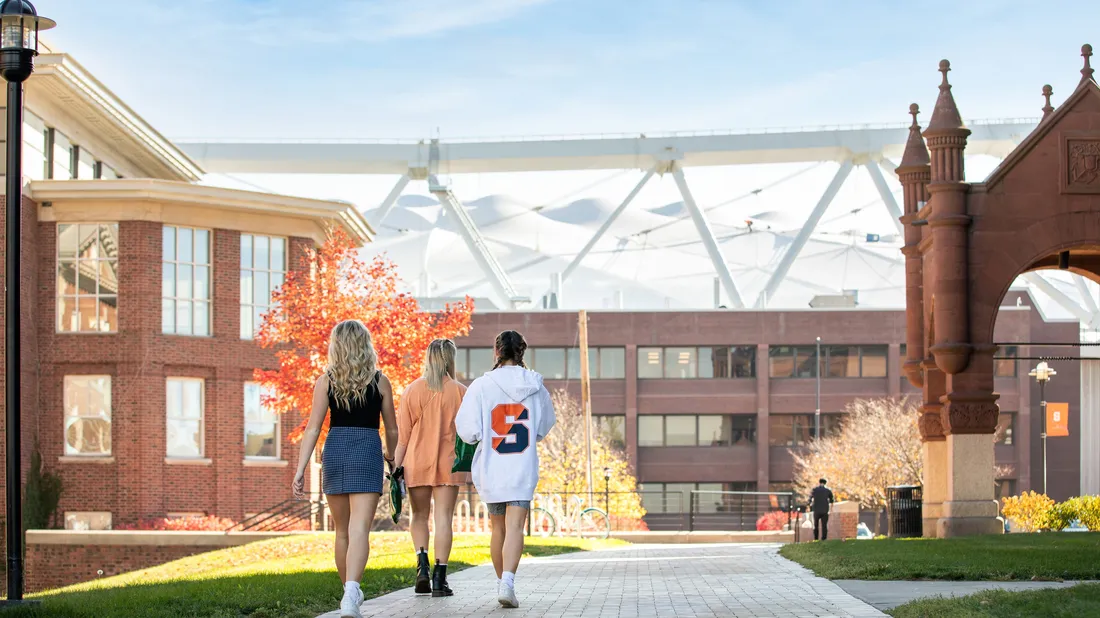 Student walk down the campus between buildings