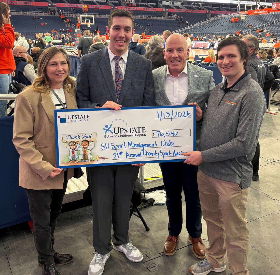 Standing together, The Upstate Foundation Development Director Cassandra Rucker, Falk College student organizer James Stickel, The Upstate Foundation Assistant Vice President of Development Dave Bartell, and Sport Management Club faculty advisor Jeremy Losak.