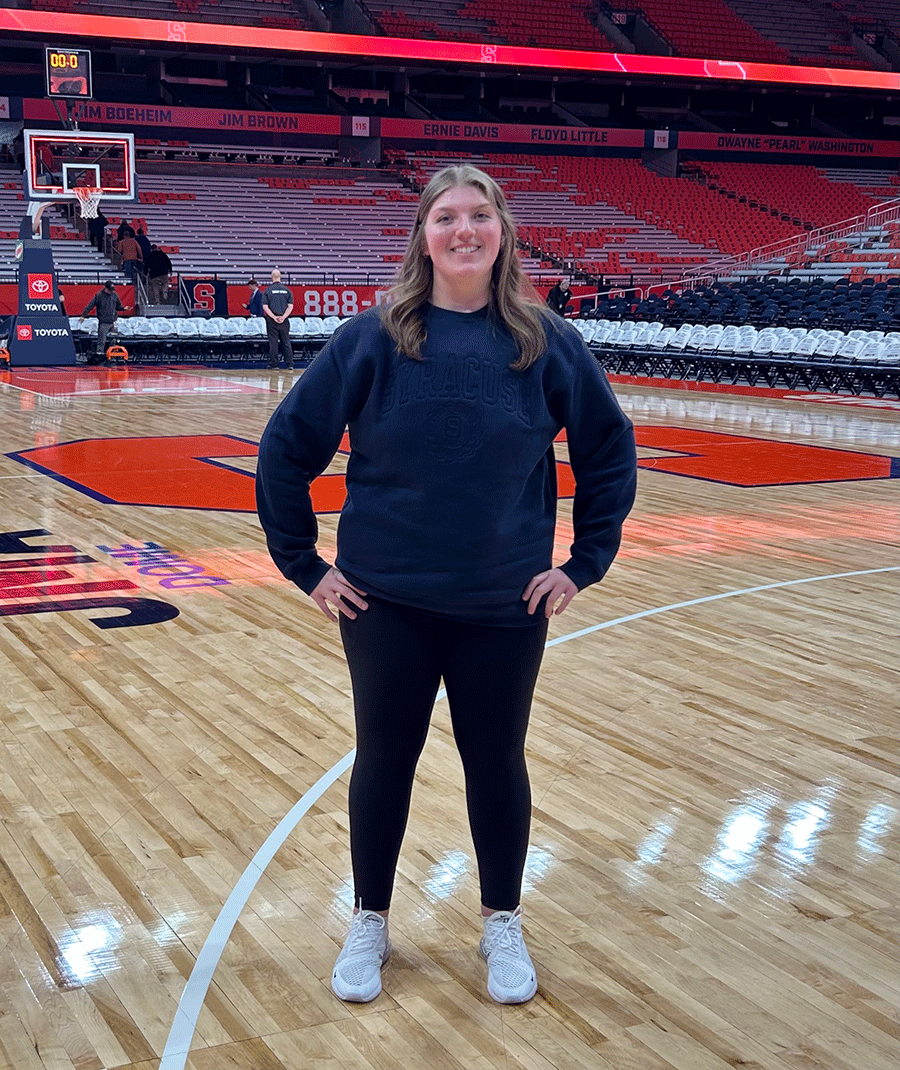 young women stands on basketball court at dome