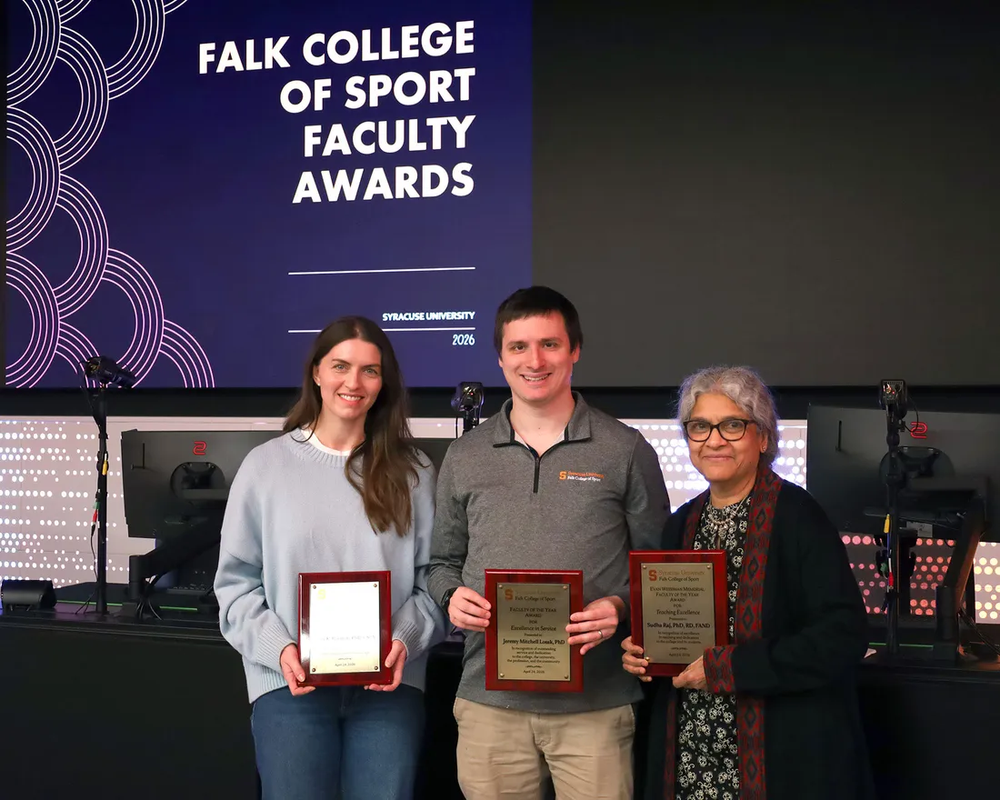 2026 Faculty of the Year award winners, Harmon, Losak and Raj are posed holding their awards.