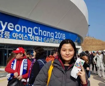 young women standing outside of PyeongChang olympics