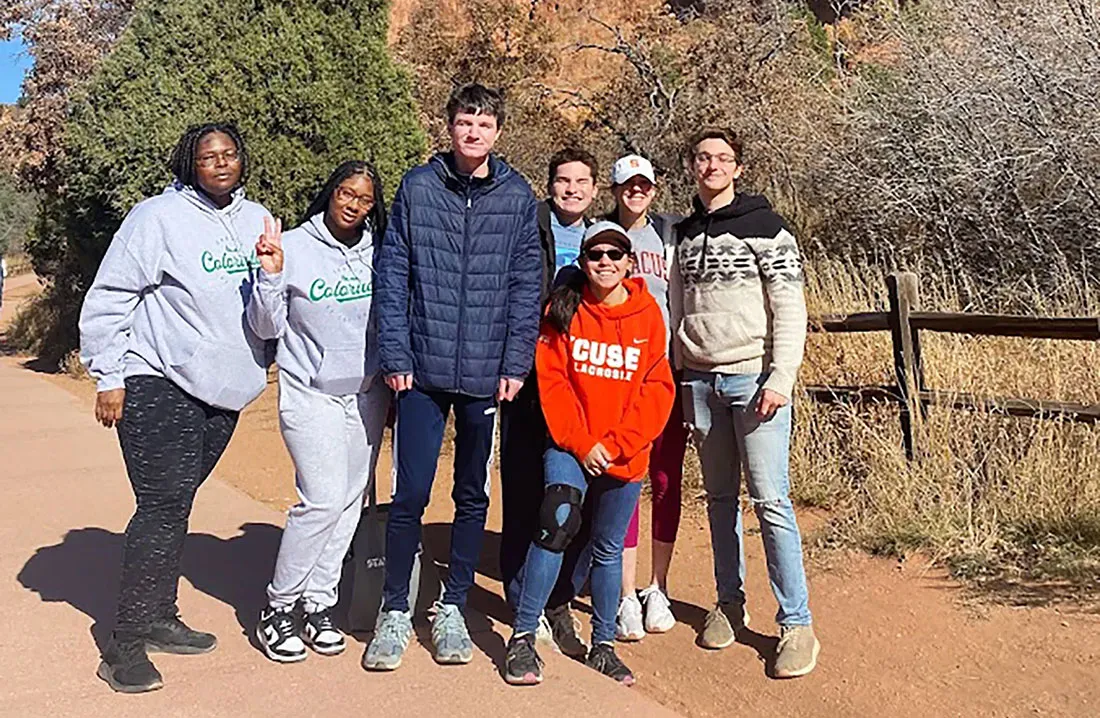 seven people standing outside on dirt road Colorado