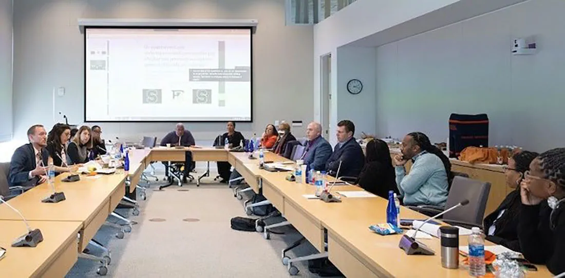 group of people in conference room viewing projection screen