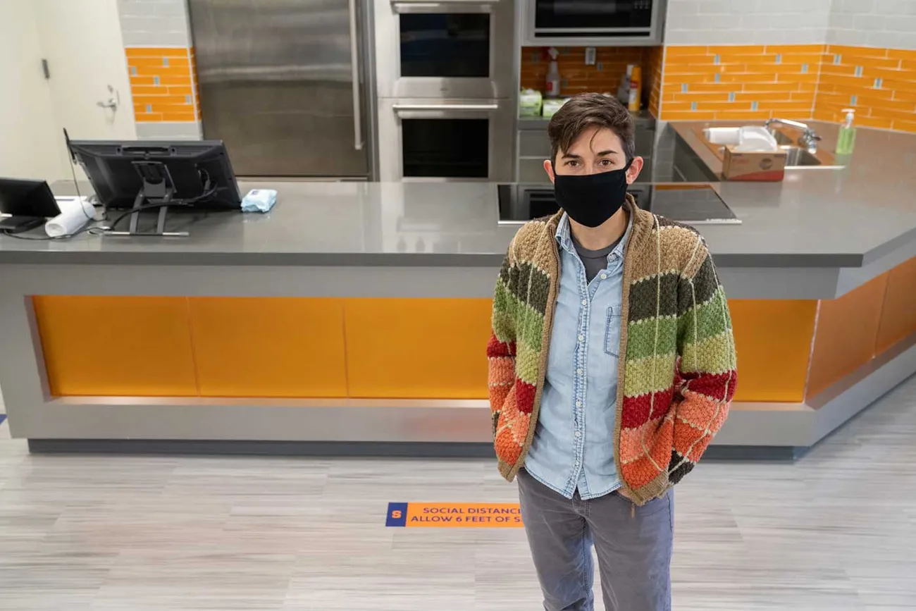 Neil Gaudel stands in front of the kitchen set up in classroom
