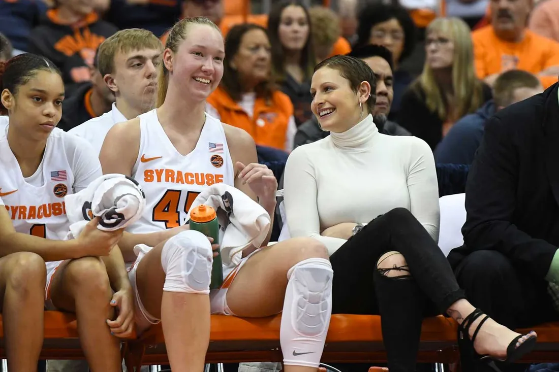 womens basketball players sitting on the bench