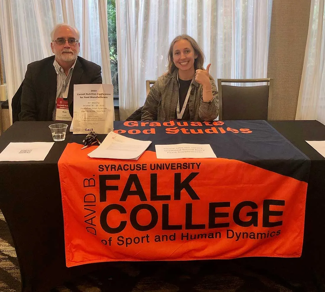 professor and graduate student tabling at Cornell conference