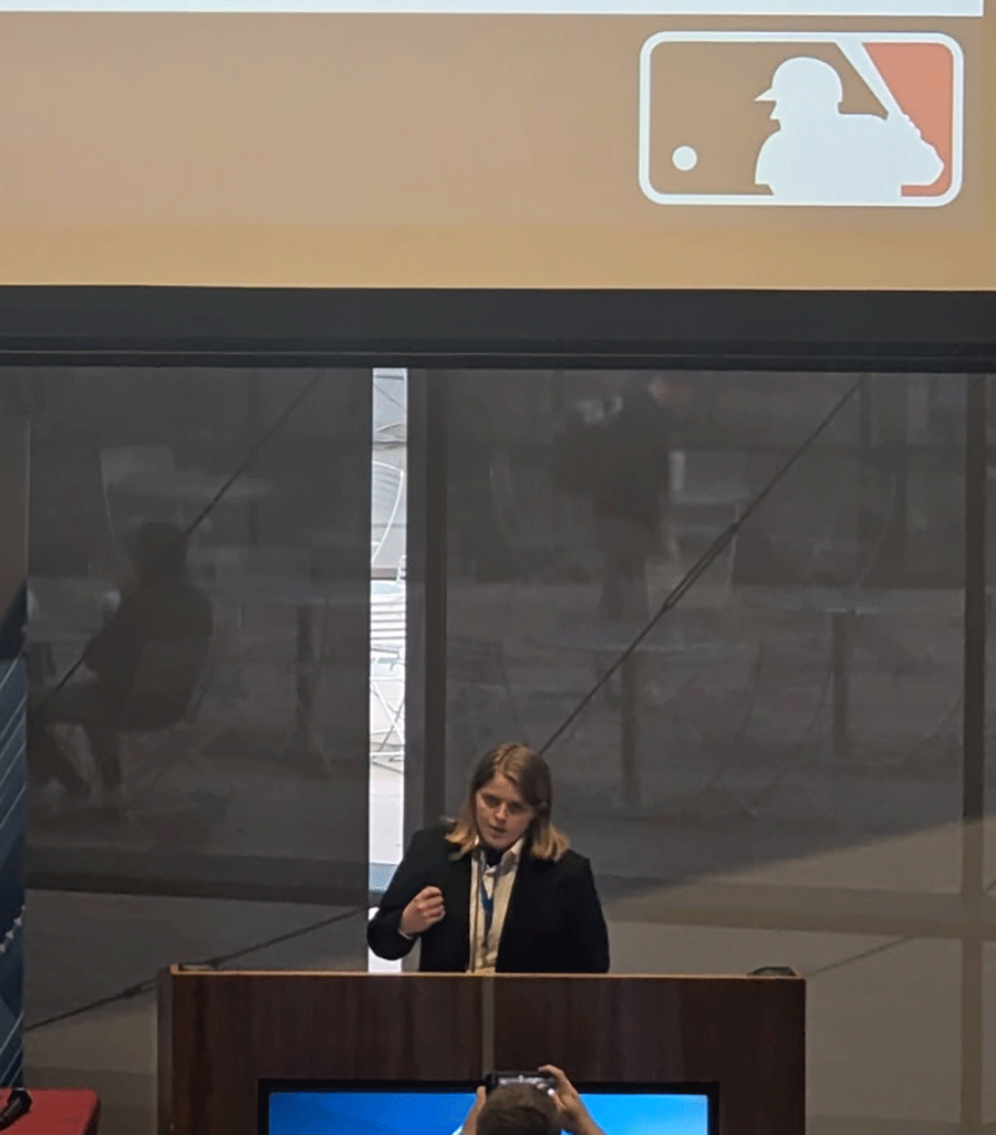 Young women standing at podium speaking