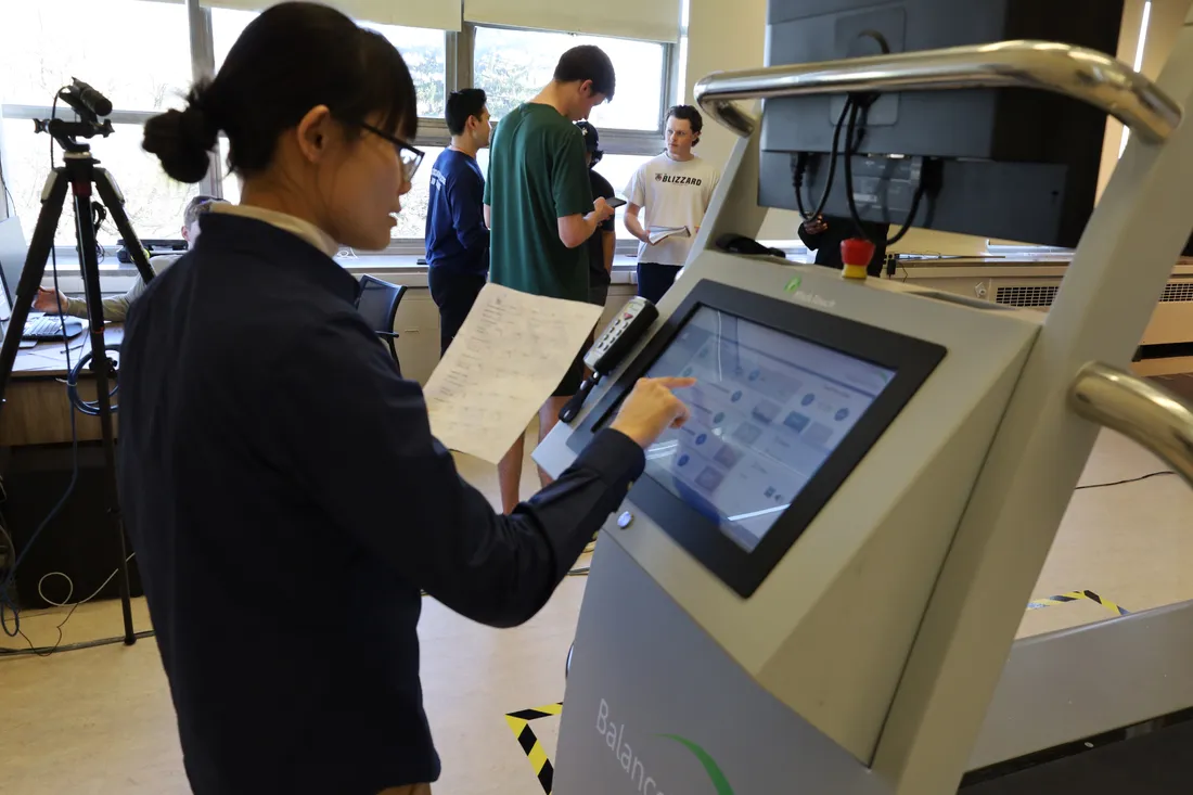 A professor works on a balance machine