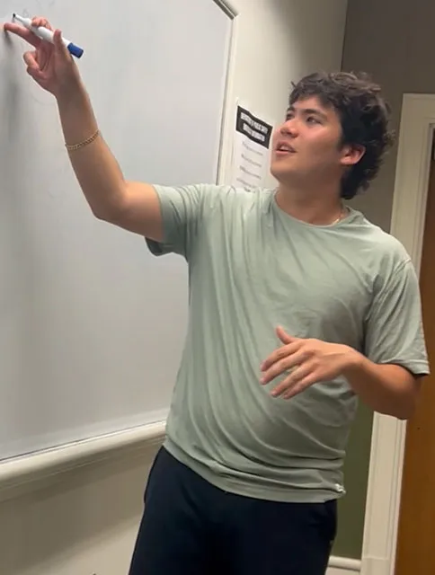 Jarrett Markman writing on a white board