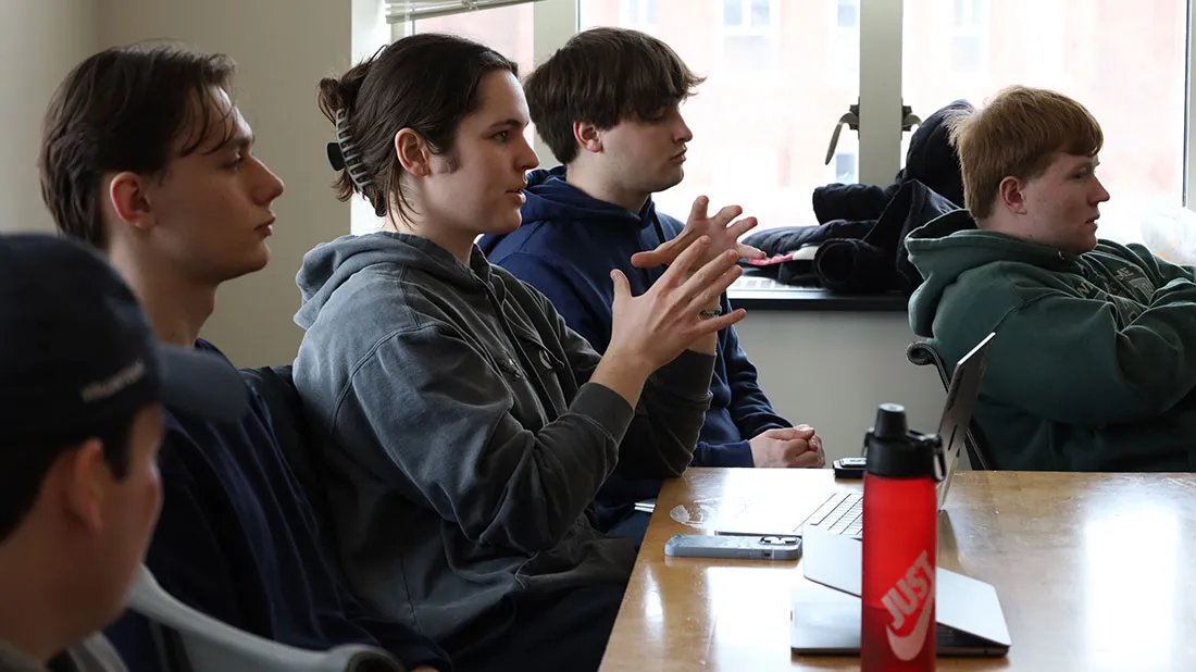 Sports analytics students asking questions of guest presenter