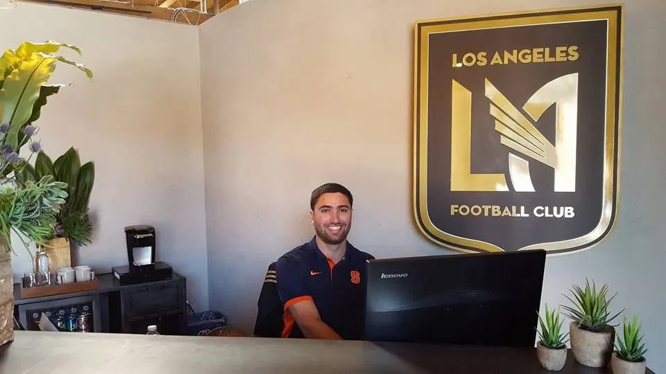 Simon Weiss sitting behind a desk at a computer