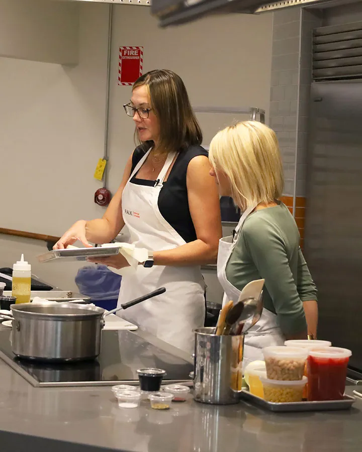 Beth Basham is cooking in a professional demonstration kitchen.