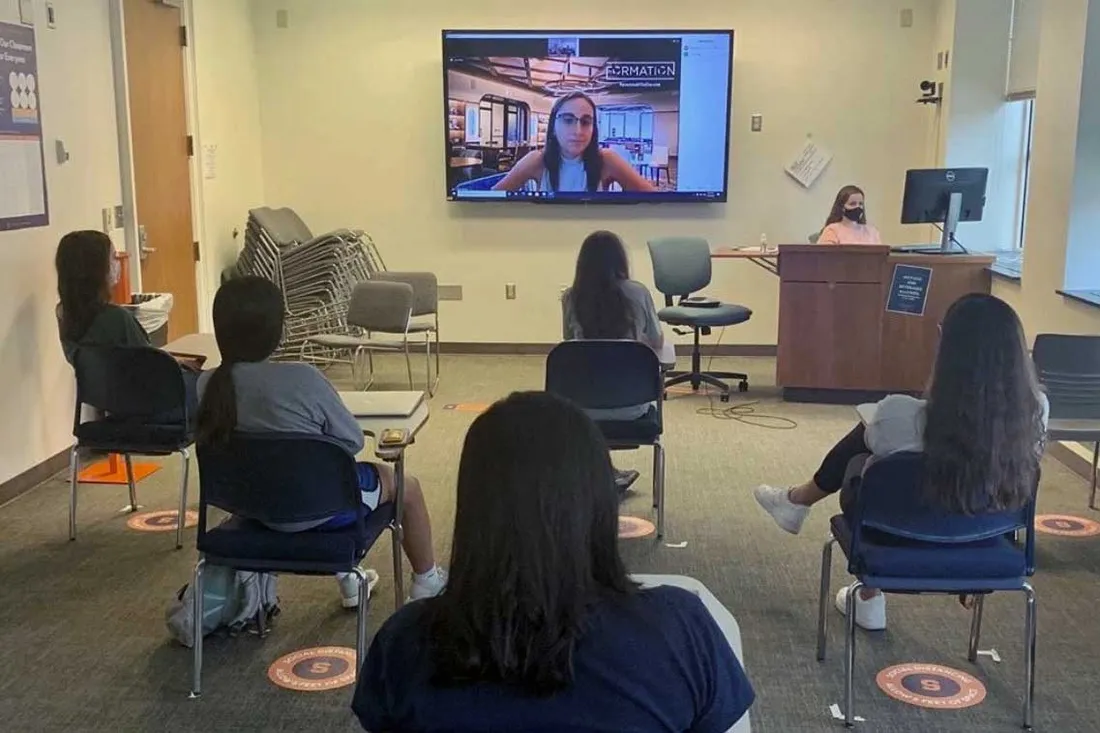 student organization meeting, presenter is virtual, and group is watchin screen