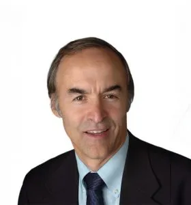 headshot of smiling, older white male wearing a suite