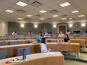 spm auction committee members meet in large classroom