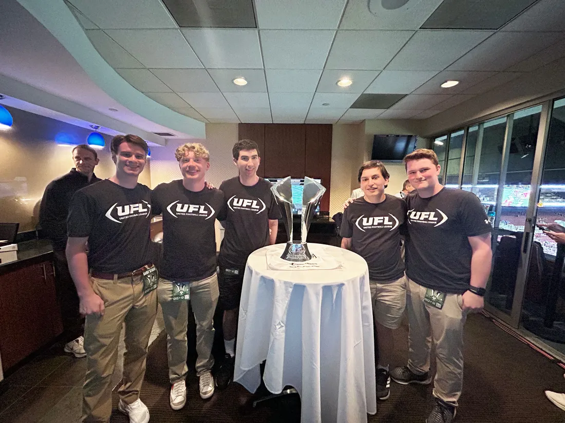 Sport analytics students in St. Louis with the UFL championship trophy