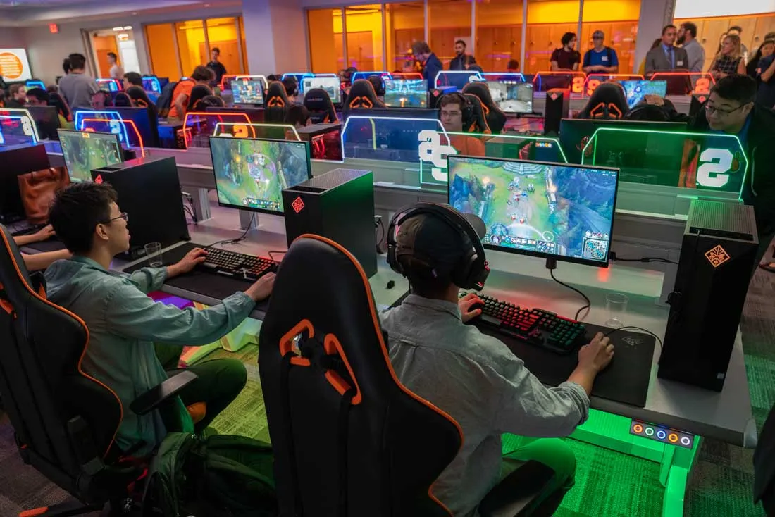 students sit playing computer games in a gaming lab