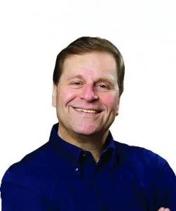 headshot of white male wearing a blue chair
