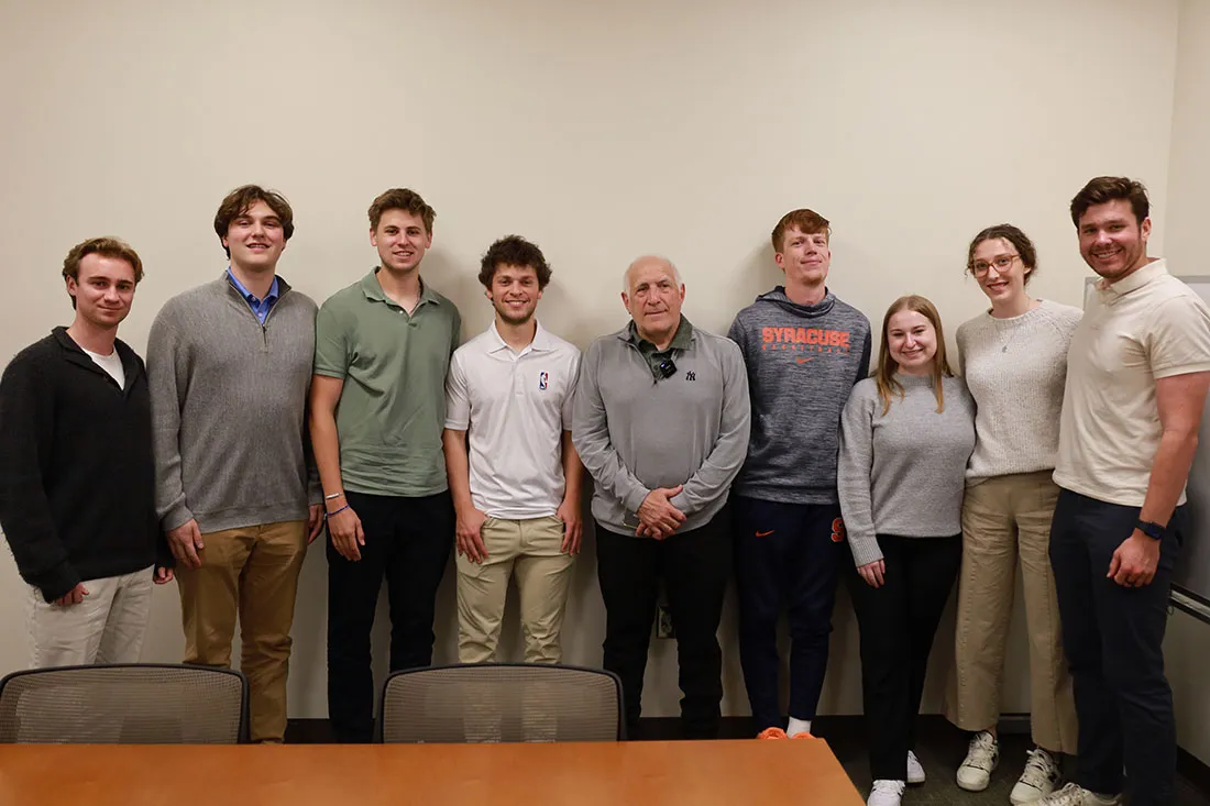 sport management students stand with Brandon Steiner