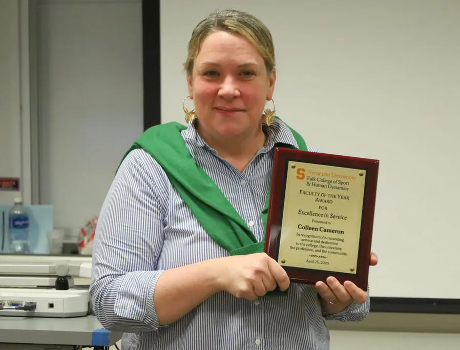 Colleen Cameron displays her Excellence in Service Award.