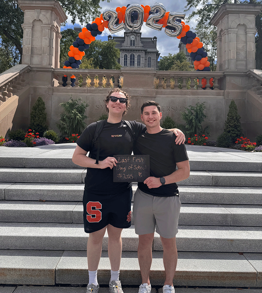 two young men standing on the stairs to the Hall of Languages on the SU campus