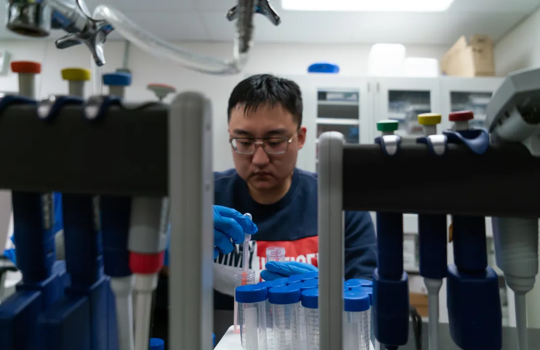 A student works with lab equipment