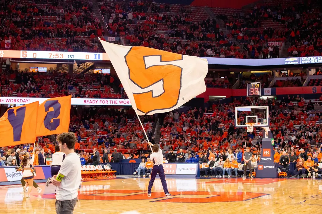 A student waves a Syracuse University flag during a game