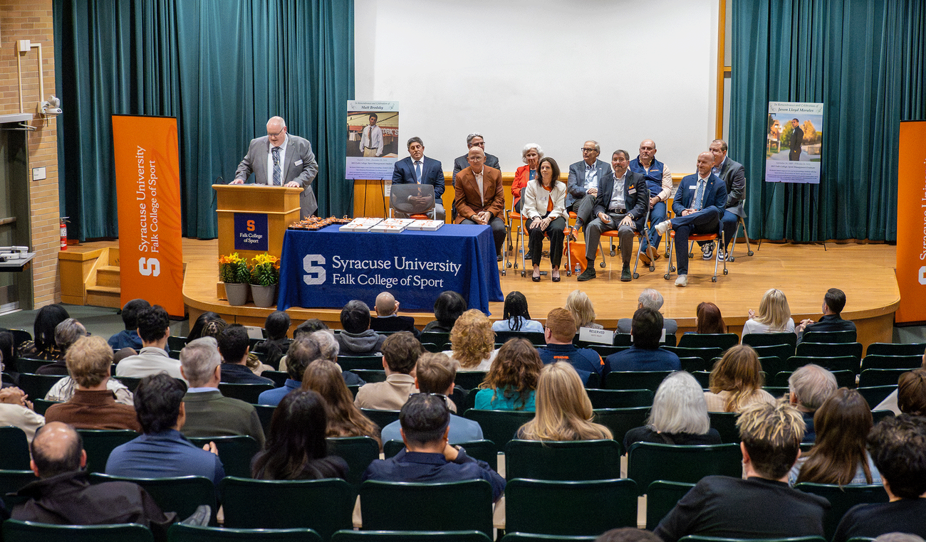 faculty presenting department awards in auditorium
