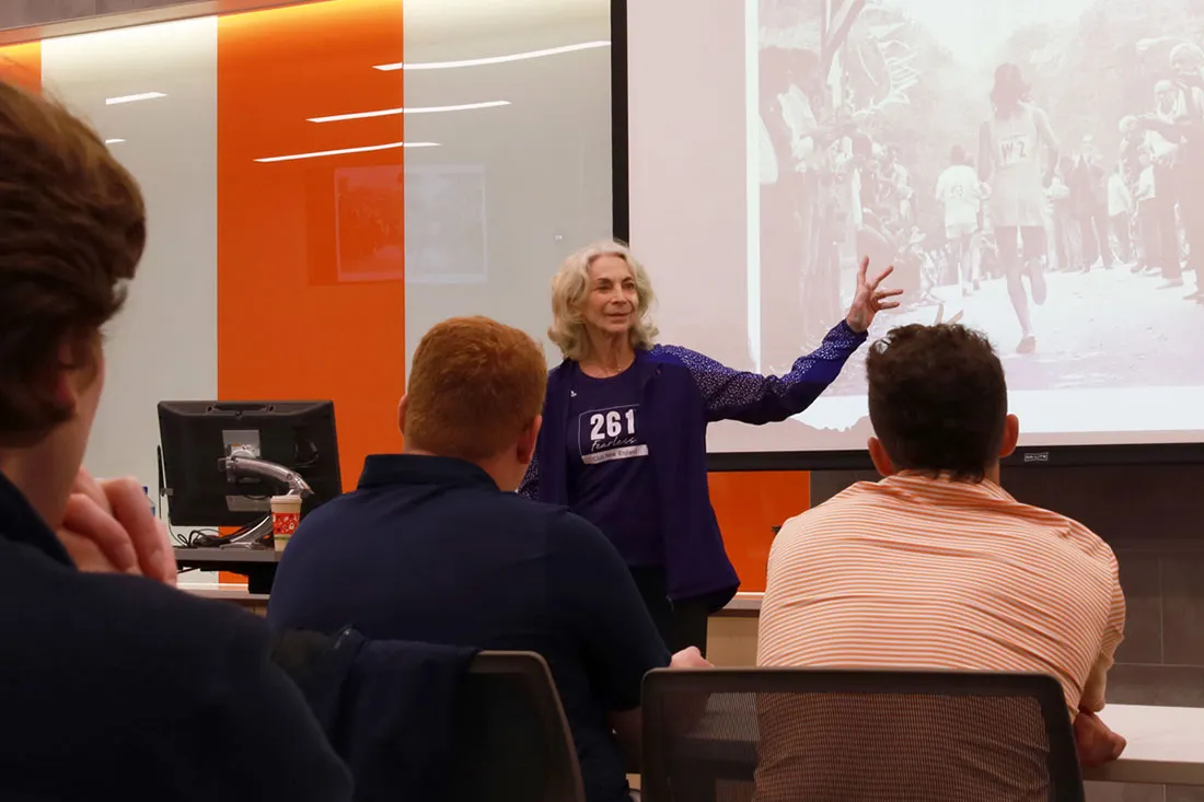 Katherine stands in front of a classroom of students giving a presentation