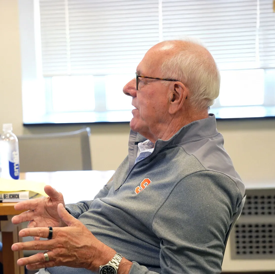 Jim Boeheim sitting at a table