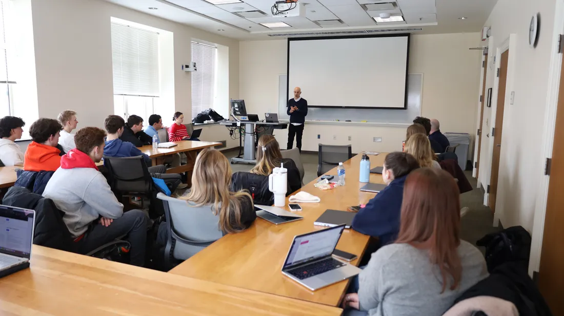 Students listen to a guest speaker in class.