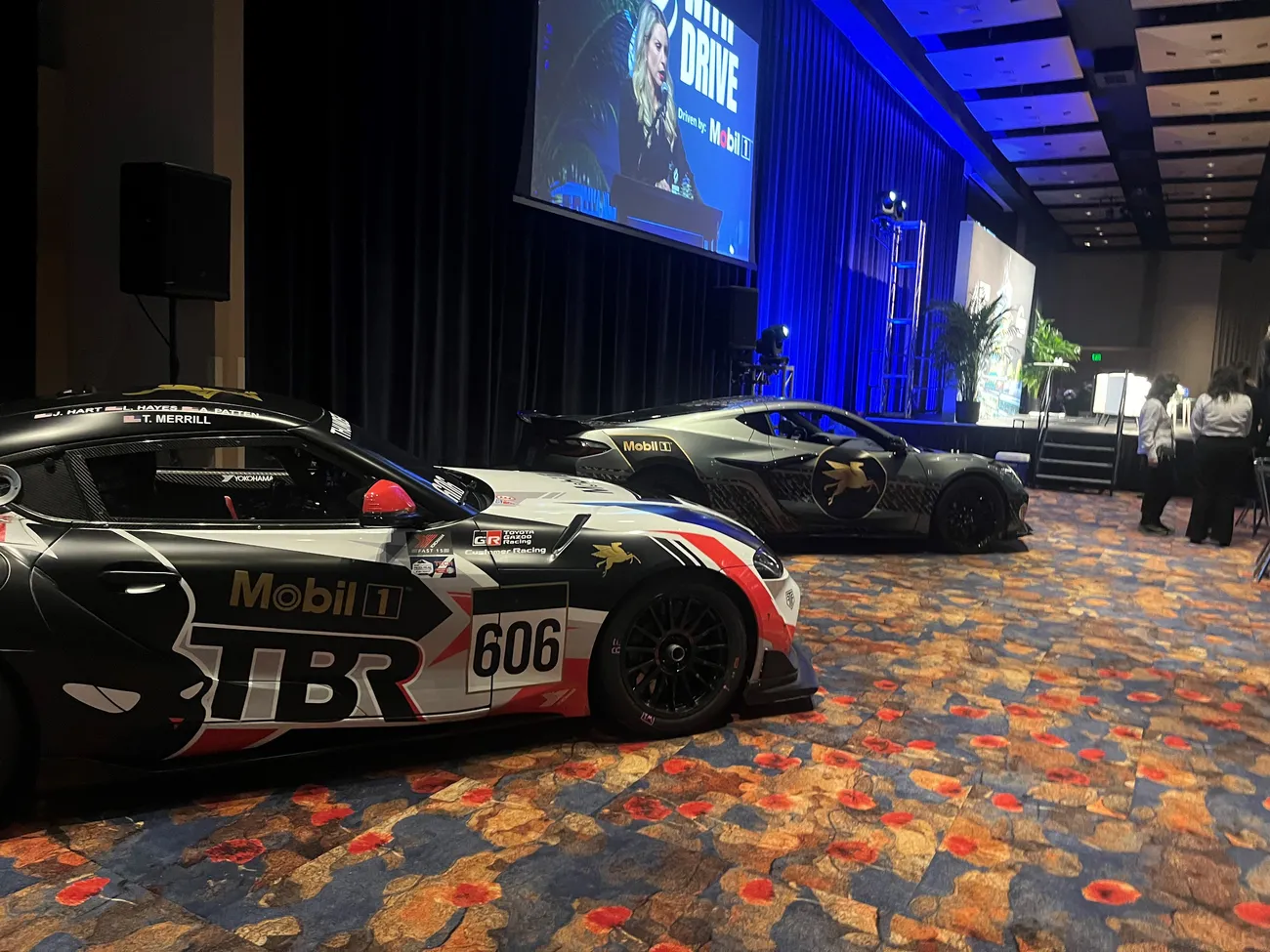 Racing cars on floor of convention center
